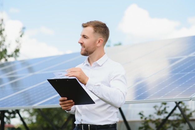 The portrait of a proud engineer smiles satisfied with his successful work Concept renewable energy technology electricity service green power