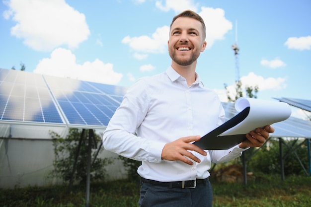 The portrait of a proud engineer smiles satisfied with his successful work Concept renewable energy technology electricity service green power