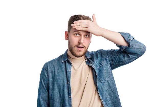 Portrait of puzzled young man holding