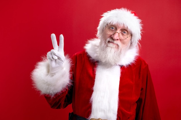 Portrait real authentic surprised shocked santa claus santa isolated on red studio background