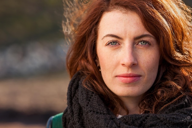 Portrait of a redhaired girl on the street She looks forward and looks confidently