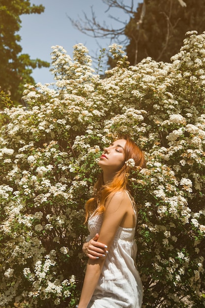 Portrait of a redhaired girl with flowers lifestyle spring concept