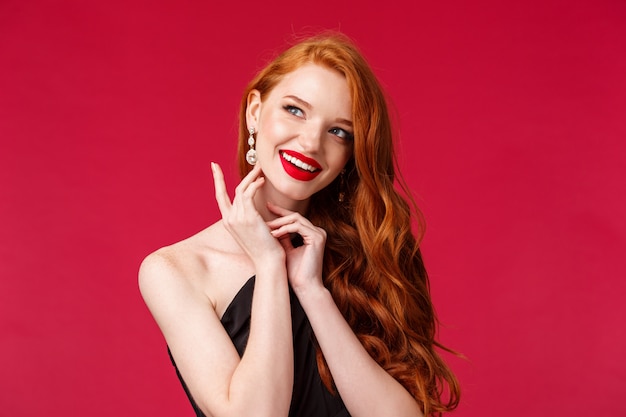 Portrait of a redhead woman in stylish black dress