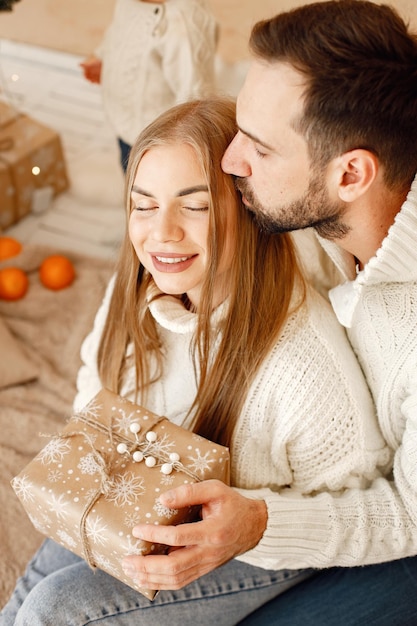 Portrait of romantic couple holding a Christmas gift