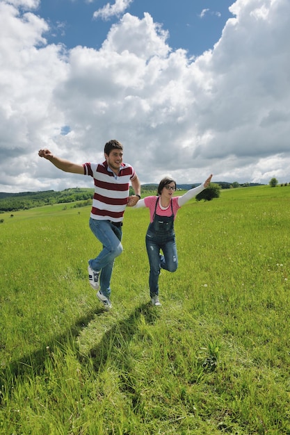 Portrait of romantic young couple in love  smiling together outdoor in nature with blue sky in background