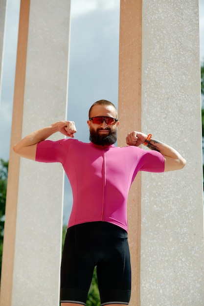 Portrait of a runner man take a rest after jogging while standing between columns copy space area for your text message information sportsman taking a break