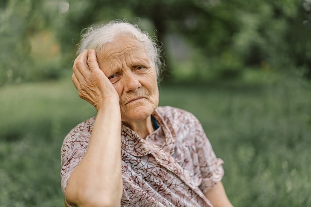 Portrait Sad old woman. Portrait of a gray-haired adult grandmother. Depressed elder suffering from loneliness