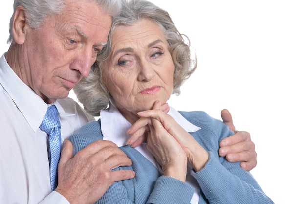 Portrait of sad senior couple isolated