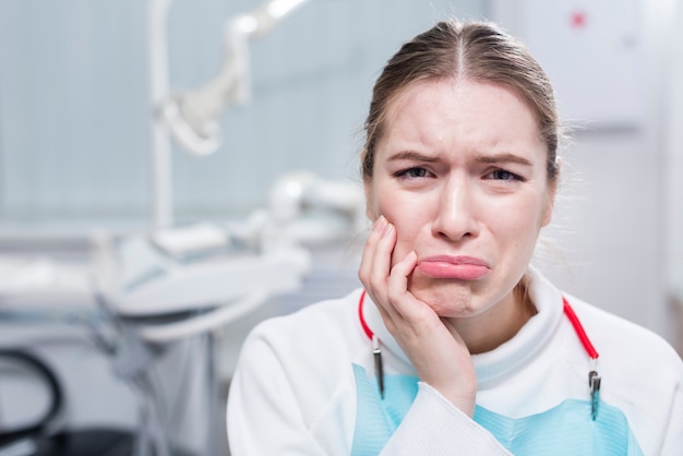 Portrait of sad woman with toothache