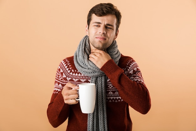 Portrait of a sad young man dressed in sweater