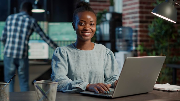 Portrait of sales assistant working on laptop to create capital profit, monitoring real time stocks and statistics. Financial investment and money banking trade with forex exchange.