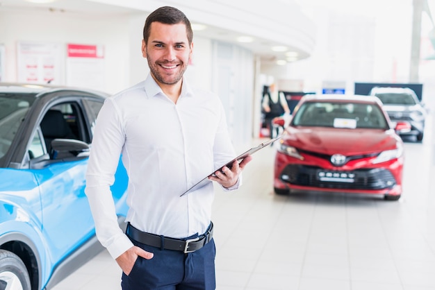 Portrait of salesman in car dealership