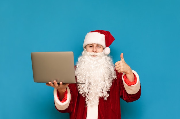 Portrait of Santa Claus with laptop