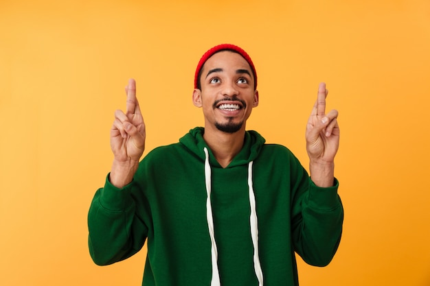 Portrait of a satisfied young afro american man in hat