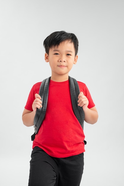 Portrait of a school boy with backpack isolated against white background