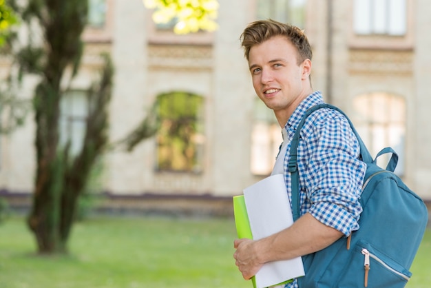 Portrait of schoolboy in front of school building