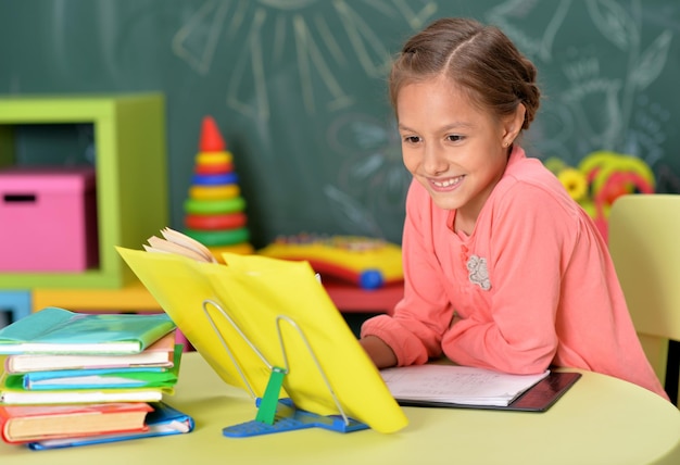 Portrait of schoolgirl doing homework in classroom