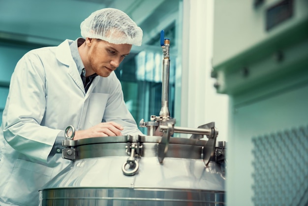 Portrait of a scientist apothecary extracting cannabis oil in laboratory