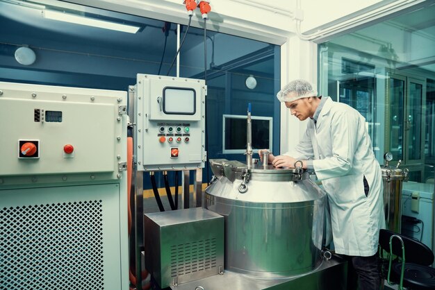 Portrait of a scientist apothecary extracting cannabis oil in laboratory