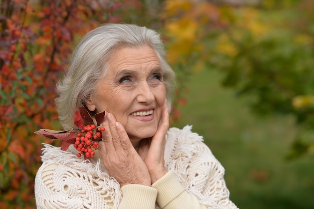 Portrait of senior beautiful woman posing with berries