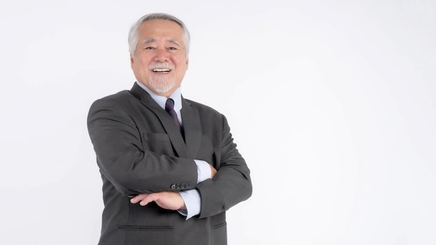 Portrait of a senior business man with suit Asian senior man old man feel happy good health standing arms crossed isolated on white background lifestyle senior male concept