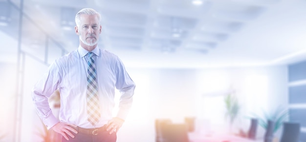 Portrait of senior businessman in front of his modern office