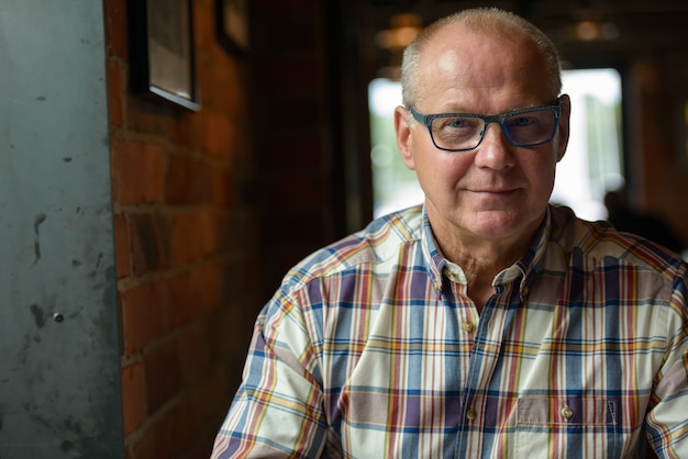 Portrait of senior businessman relaxing at the coffee shop