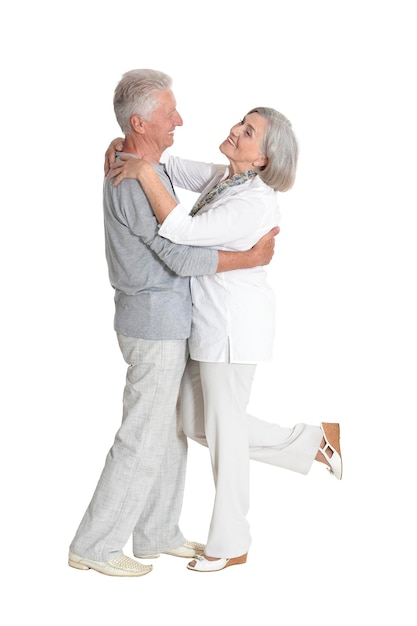 Portrait of a senior couple dancing on white background