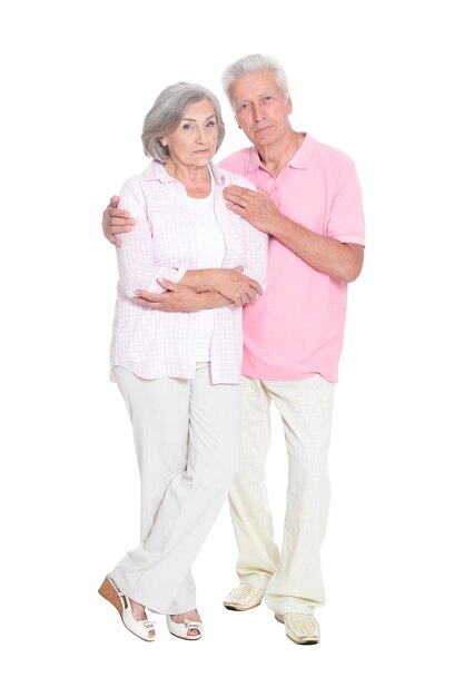 Portrait of senior couple embracing on white background