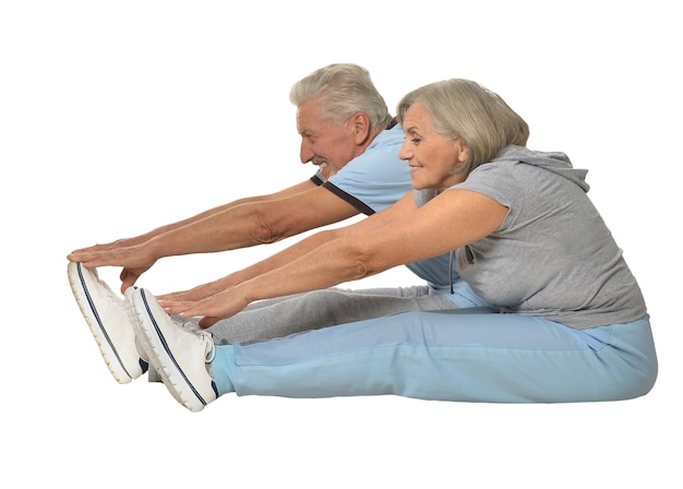 Portrait of Senior Couple Exercising On White Background