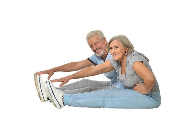 Portrait of Senior Couple Exercising On White Background