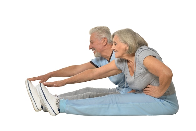 Portrait of Senior Couple Exercising On White Background