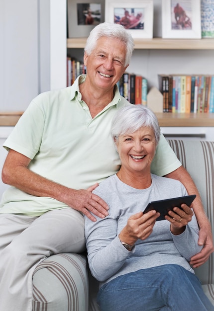 Portrait senior couple and smile with tablet sofa and home for social media online news app and ebook Happy old man woman and digital technology for subscription website and internet connection