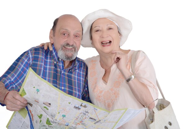 Photo portrait of senior couple with map looking sights.