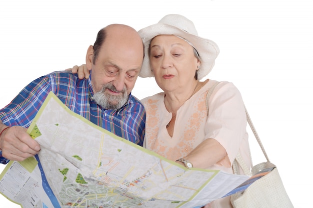 Photo portrait of senior couple with map looking sights.