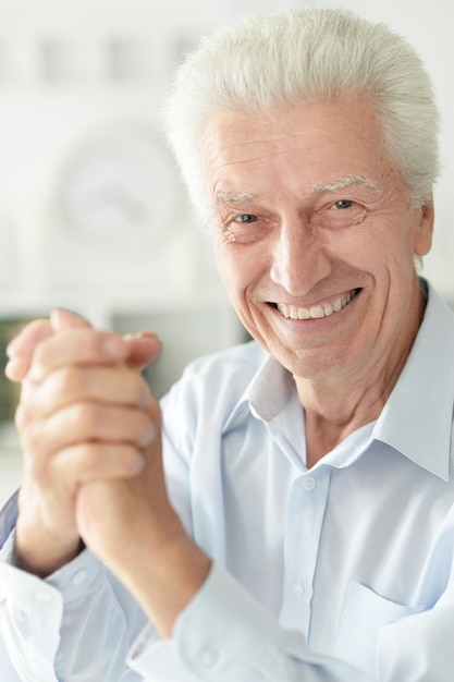 Portrait of senior man shaking hands isolated on white background