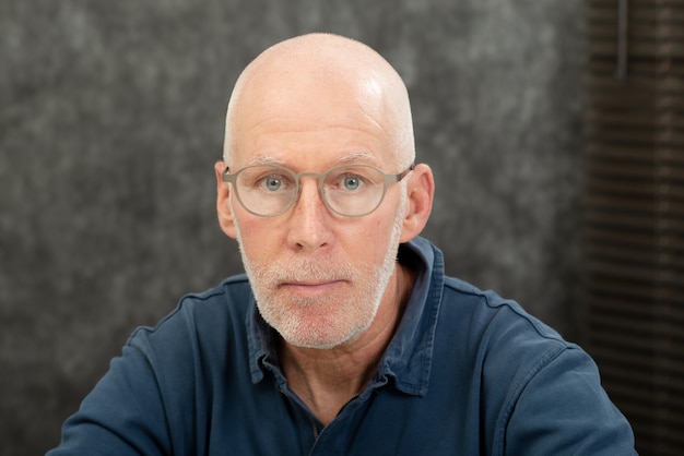 Portrait of senior man with beard and glasses