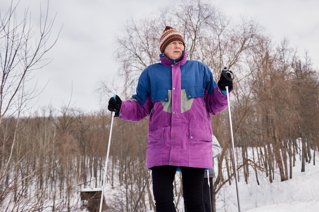 Portrait of a senior skier in a winter forest