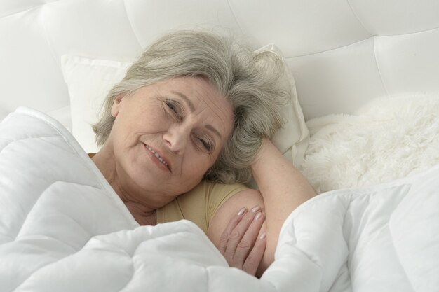 Portrait of a senior woman in a bed