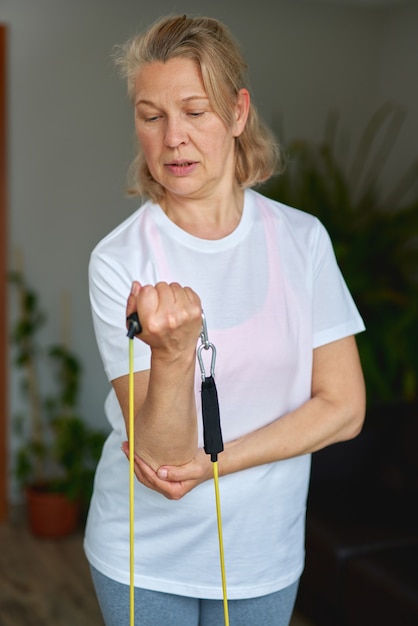 Portrait of senior woman exercise in for sports at home.