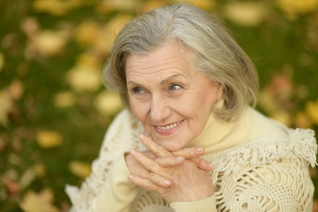 Portrait of Senior woman walking in the park in autumn