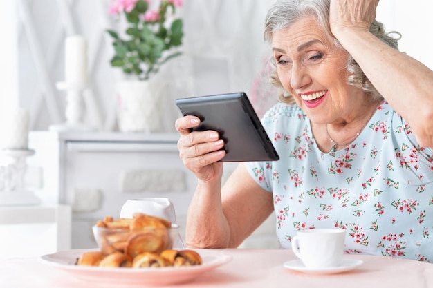 Portrait of senior woman with tablet pc