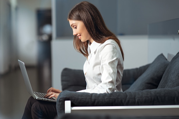 Portrait of a serious businesswoman using laptop in office