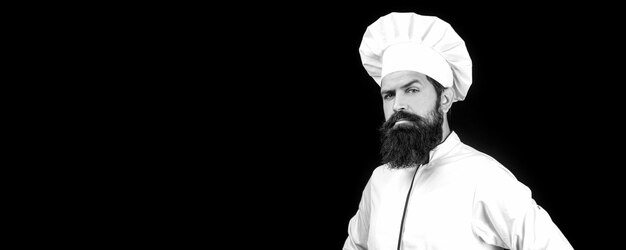 Portrait of a serious chef cook. Chef, cooks or baker. Bearded male chefs isolated on black. Cook hat. Serious cook in white uniform, chef hat