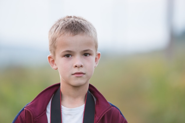 Portrait of a serious child boy outdoors