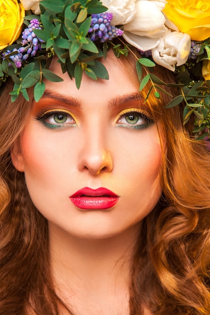 Portrait of sexy adult woman with flowers in studio