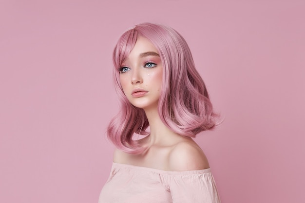 Portrait of a sexy young woman with pink hair. Perfect hairstyle and hair coloring