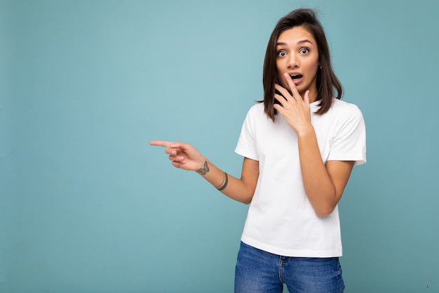 Portrait of shocked astonished young  nice winsome  woman with sincere emotions