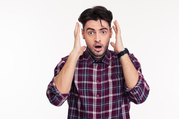 Portrait of a shocked man  isolated on a white wall