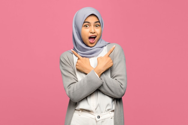 Portrait of shocked young Asian woman keeping arms crossed